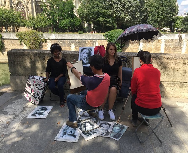Students having their caricatures drawn in France 