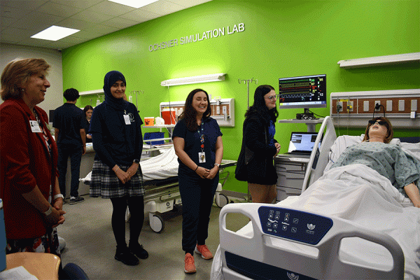 University of New Orleans President Kathy Johnson (far left) visits Kenner Discovery Health Sciences Academy, which has partnered with UNO to create a yearlong residency placement program for education majors.