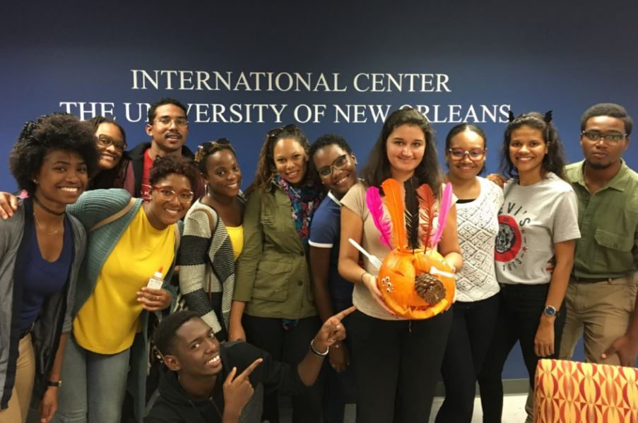 Students showing off the pumpkin they carved