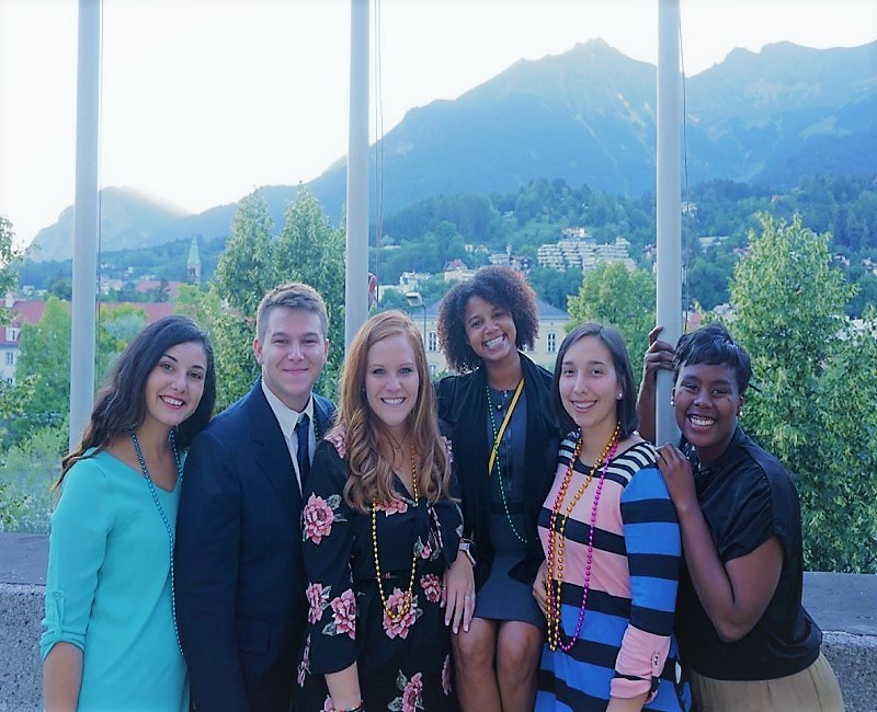 group of students posing in front of mountains in austria