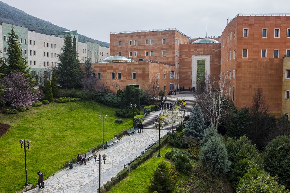 Entrance to beautiful red brick campus building, with lush green grass