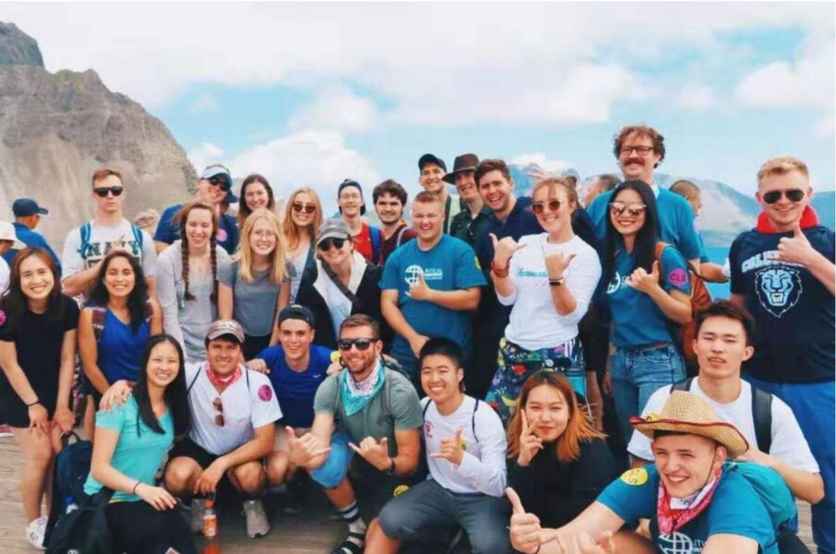 Students in the CLS scholarship program pose for a group picture in front of mountains