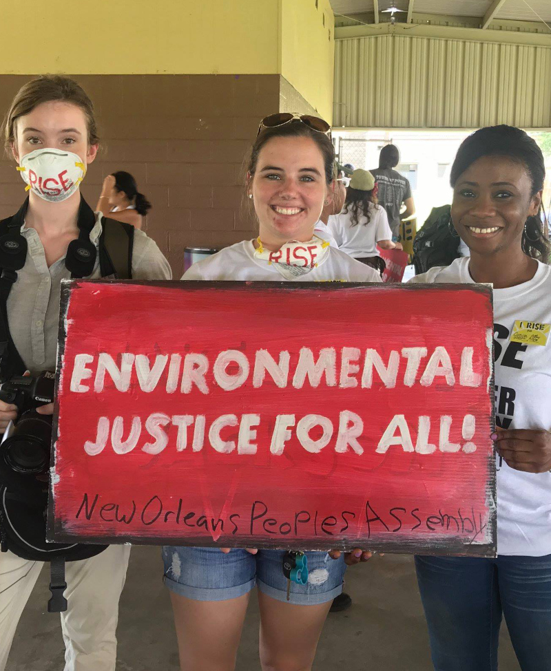 The people holding a sign reading "Environmental Justice for All"