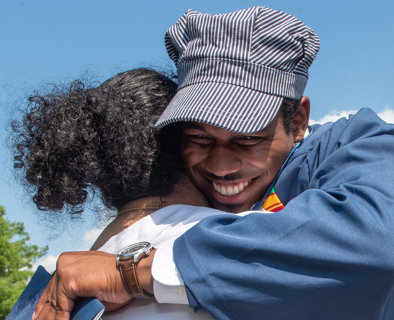 Proud Parent hugging proud son after commencement