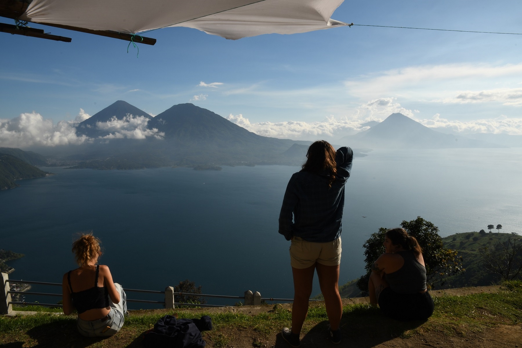 Students in Guatemala overlooking a body of water with mountains in the distance