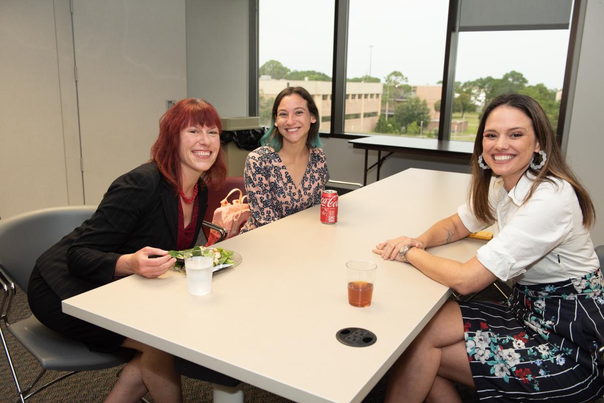 Students from the inaugural cohort catch up over food