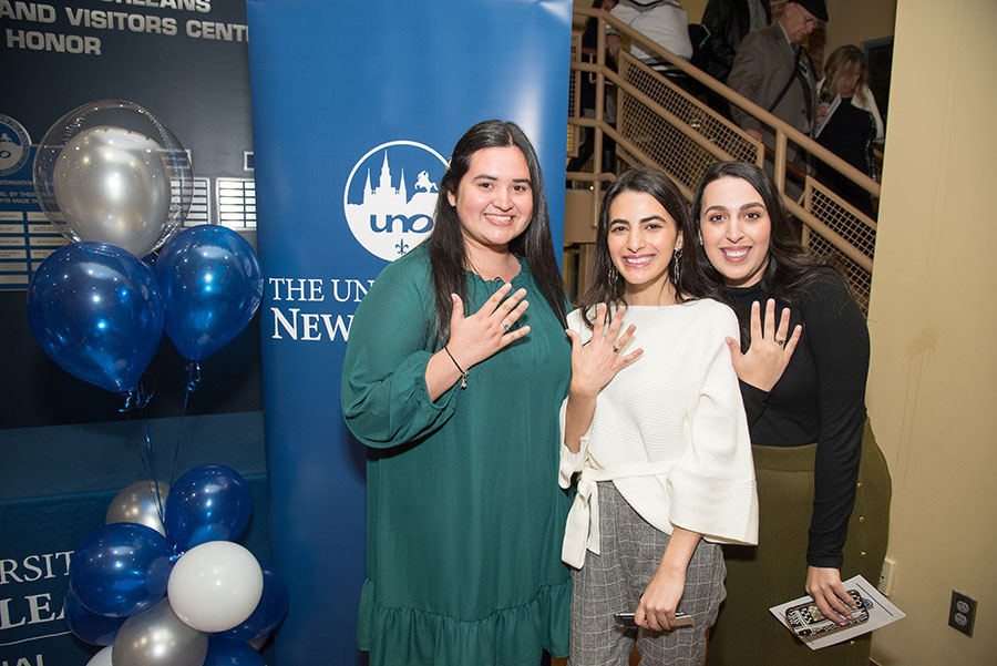 Graduates show off their class rings. 