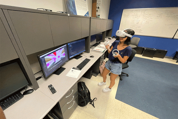 UNO computer science student Lisa Gilmore-Montero, a member of UNO’s International Game Developer's Association, demonstrates the use of virtual reality (VR) equipment.