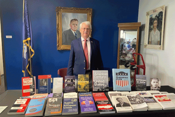 University of New Orleans history professor and Center Austria director Günter Bischof stands in front of a display of some of his published works.