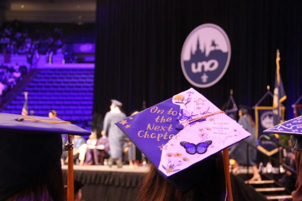 A graduation mortarboard reading "On to the next chapter".