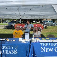 Students behind a UNO table at Bug Fest