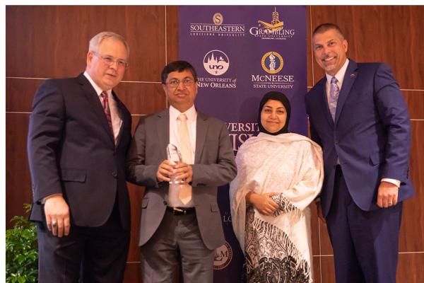 University of Louisiana System President Jim Henderson presents the outstanding faculty award to UNO finance professor M. Kabir Hassan, who is joined by his wife, Dr. Tahmina Hassan, MD and President John Nicklow.  The award was presented during the annual For Our Future Conference held at UL Lafayette.