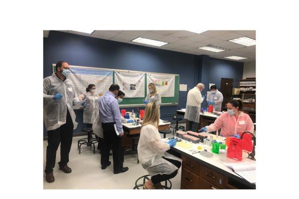 Scientists from public and private sector labs test DNA samples using the SpermTrap process during a forensics workshop Monday sponsored by the University’s Advanced Materials Research Institute (AMRI) and InnoGenomics Technologies. 