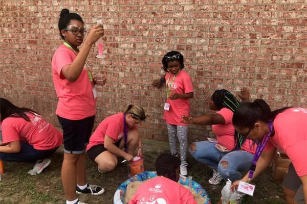 The weeklong GE Girls camp held at the University of New Orleans introduces campers to various STEM careers, including computer programming and forensics, through hands-on activities such as a session called outdoor chemistry.