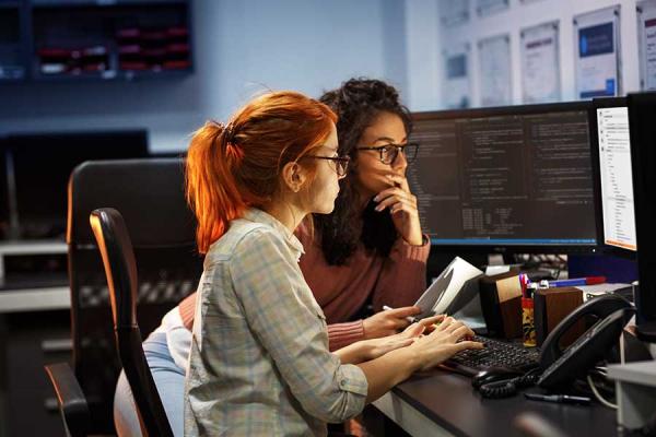 Two women working at a computer