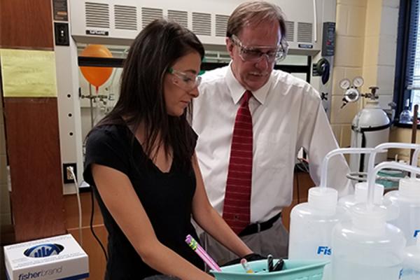 University of New Orleans chemistry professor Mark Trudell (right) and doctoral student Jumanah Hamdi work in the lab.