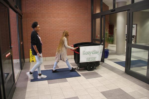 Two of the university’s most visible green initiatives are a new recycling team and the recent installation of thousands of energy efficient bulbs around campus.