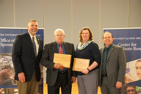 President John Nicklow (far left) stands with award winners Allan Millett, Wendy Schluchter and Matt Tarr, vice president for research and economic development, during the annual Achievements in Research, Creativity and Scholarship awards ceremony.