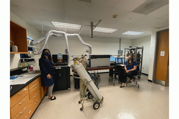 UNO chemistry professor Phoebe Zito (left) and her graduate student Deja Hebert are pictured with the inductively coupled plasma triple quadrupole mass spectrometer—the ICP-QQQ.