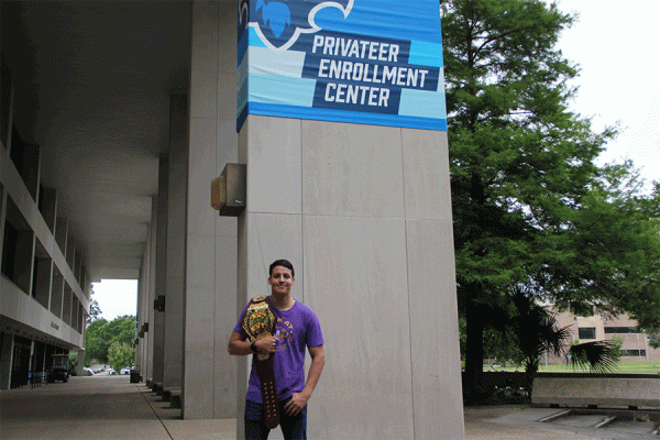 University of New Orleans senior Perry Hawxhurst poses with his championship belt won as part of the wrestling tag team Hawx Aerie with his dad, Luke. 