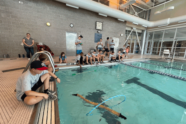 Students test out their robotic eels at the University of New Orleans recreation center’s pool. The robots were created as part of a weeklong School of Naval Architecture and Marine Engineering STEM camp funded by the U.S. Office of Naval Research.
