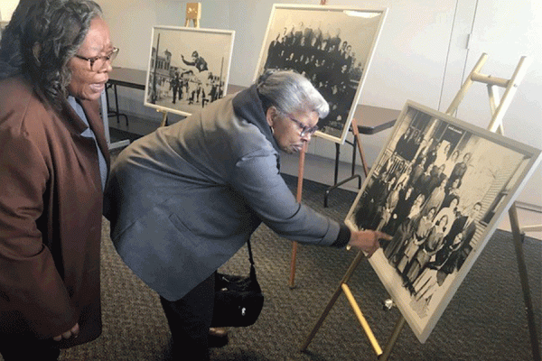 Jenny Branch, left, and her sister Edna Branch, look at pictures included in the Orleans Parish School Board Collection housed at the University of New Orleans’ Earl K. Long Library during a reception held in 2019.