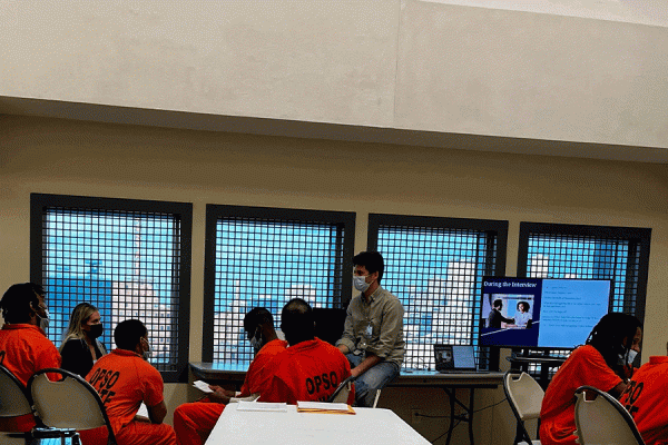 UNO professor JP Messina (at center in jeans) and students teach important jobs preparedness skills to incarcerated people at the Orleans Justice Center who are nearing release.