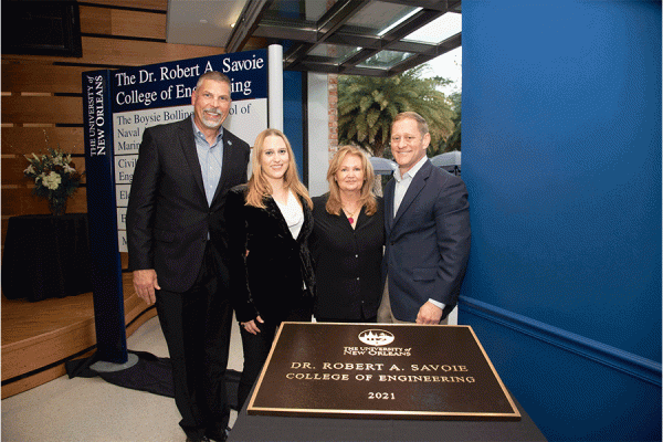 UNO President John Nicklow, Mallory Savoie, Dr. Bobby Savoie and Lori Savoie celebrate the naming of the Dr. Robert A. Savoie College of Engineering at an on-campus event on Tuesday, Dec. 14.