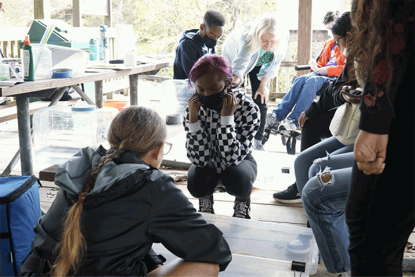 Dinah Maygarden (center in green shirt), research associate and science education program director at UNO’s Pontchartrain Institute for Environmental Science, discusses ways to create new land with students from New Harmony High School in New Orleans.