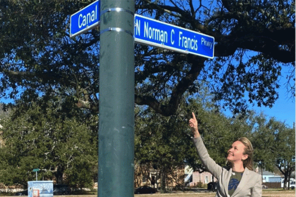New Orleans City Councilwoman Helena Moreno points to the newly renamed Norman C. Francis Parkway sign.
