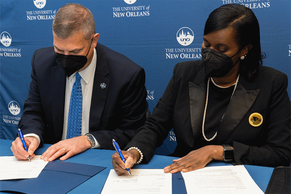 UNO President John Nicklow and Lanissa Grogan Stewart, president of the National Coalition of 100 Black Women - Greater New Orleans Chapter, Inc., sign a memorandum of understanding during a ceremony on the UNO campus.  