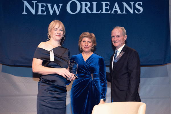 UNO alumna Sabrina Farmer (left) stands with President Kathy Johnson and  Ricky Burke, president of the UNO Alumni Association, at the Distinguished Alumni Gala held Thursday, Nov. 9, 2023 at the National WWII Museum. 