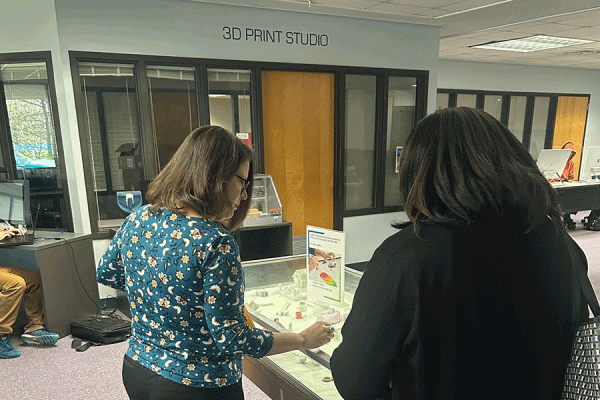 Johannah White, (left) information literacy librarian, explains the various creations made with 3D printers in The Innovation Lab at the Earl K. Long Library. 
