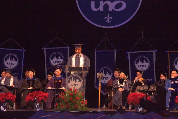 Speaker Mike Jackson delivers the commencement speech on stage.