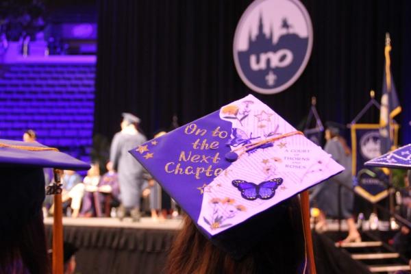A graduation mortarboard reading "On to the next chapter".