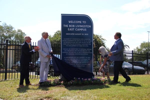 A sign reading "Welcome to the Bob Livingston East Campus" is unveiled