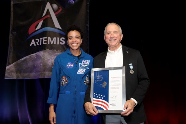 Thomas J. Wallbillich III receives the NASA Silver Snoopy Award, presented by astronaut Jessica Watkins in recognition of contributions to human spaceflight mission